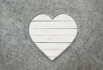 Heart of felt with white wooden boards
