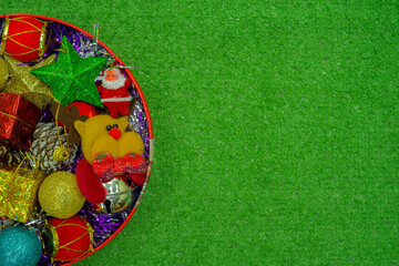 Christmas gift decorated with green branch, pine cone, gift bag red and silver beads garlans on knitting blacket . Xmas or New year green background, Merry Christmas greeting card.