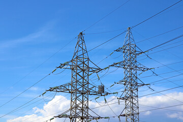 Large tall metal pole with power lines. Clean and sustainable energy. Sale of Electricity.