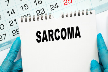 The doctor points to the text SARCOMA, medical concept