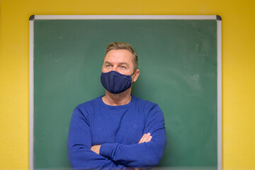Thoughtful male teacher looking off to the side