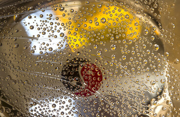 Transparent spheres are located on a yellow-brown mirrored background with black and red...