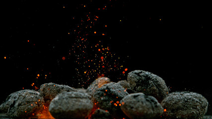 Charcoal briquettes ready for barbecue grill, close-up.