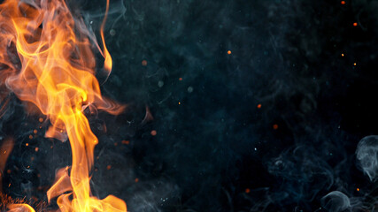 Fire flames with sparks on a black background, close-up