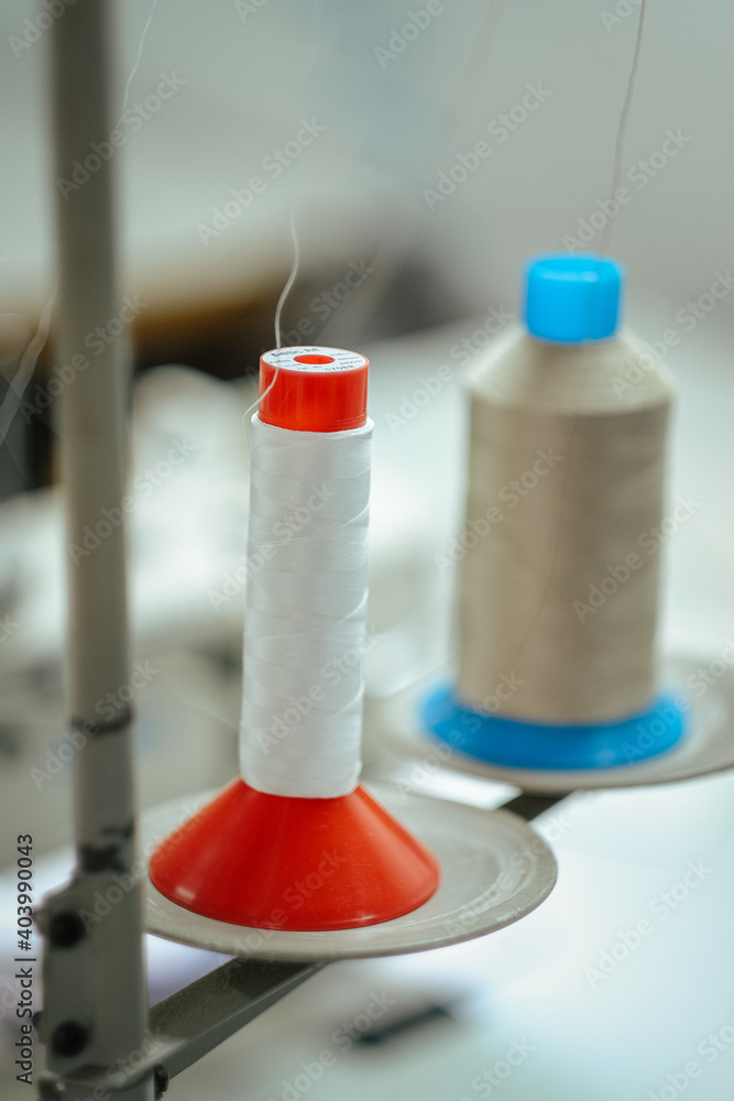 Canvas Prints Vertical selective focus shot of sewing threads