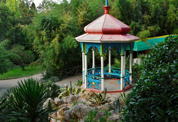 Decorative Chinese gazebo in the Nikitsky Botanical garden. Dense subtropical vegetation