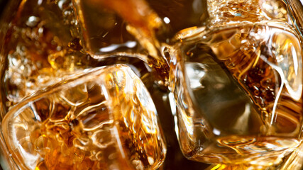 Ice Cube falling into Glass of Whisky, Freeze Motion, Macro Shot.