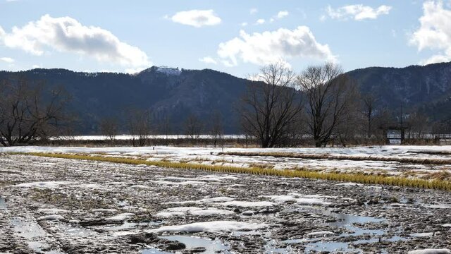 Images of a Japanese farming village in winter with snow on the ground.