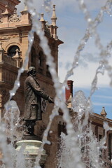 Statue in Valladolid, Spain, surrounded by jets of water from a fountain