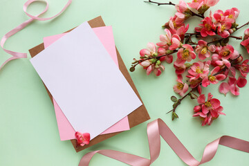 mockup greeting card. spring composition. blooming branch of azalea and envelope for text. congratulation. invitation