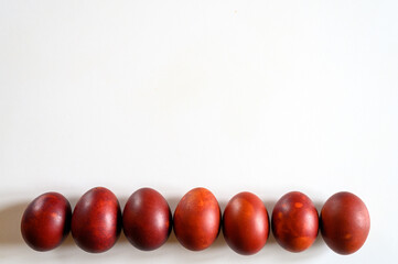 easter eggs painted onion husks on a white background. coloring the eggs according to the old natural eco-friendly method with peeled onions. space for text