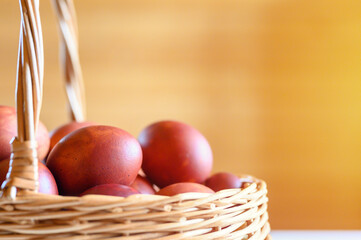 easter egg painted onion husks in a wicker wooden basket. coloring the eggs according to the old eco-friendly method with peeled onions. going to celebrate easter. flare. selective focus