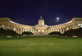 Kazan Cathedral in the night lights. Colonnade with a Central portico and a high dome against the blue sky with the moon. Architecture of the XIX century