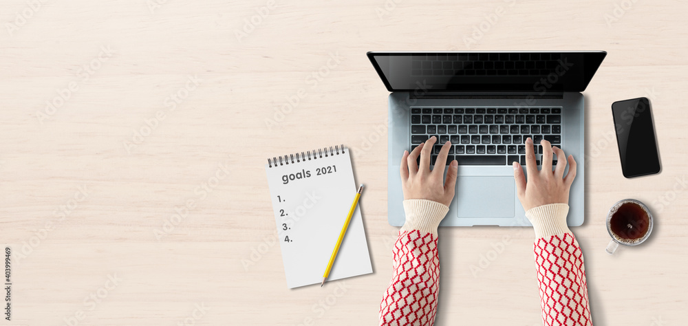 Aufkleber concept work from home, person using a laptop computer with blank screen, mug of coffee on the table