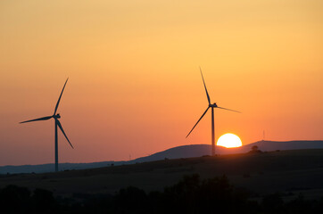 wind turbine and sun on sunset - 404000089