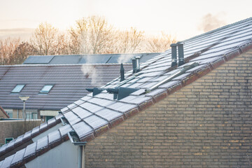 Rime on the roofs of houses on a cold winter morning