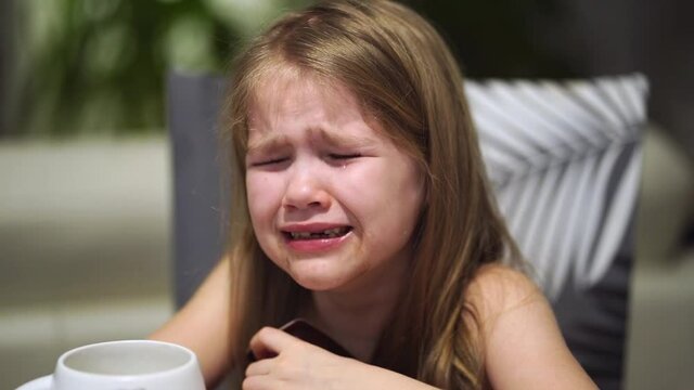 childish hysteria. The little girl cries and can't calm down. domestic conflicts and childish grievances. baby crying
