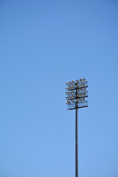 Low Angle View Of Stadium Lights Isolated Against Clear Blue Sky