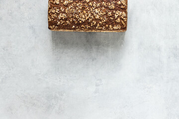 Wholegrain bread on a grey concrete background