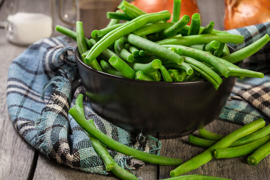 Raw Green Beans In A Black Dish