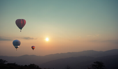 Abstract blurred of Hot air balloon above high mountain at sunset