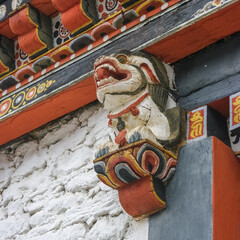 Colorful traditional painted snow lion wood sculpture used as corbel in Tashichho dzong in Thimphu, Bhutan © Cyril Redor