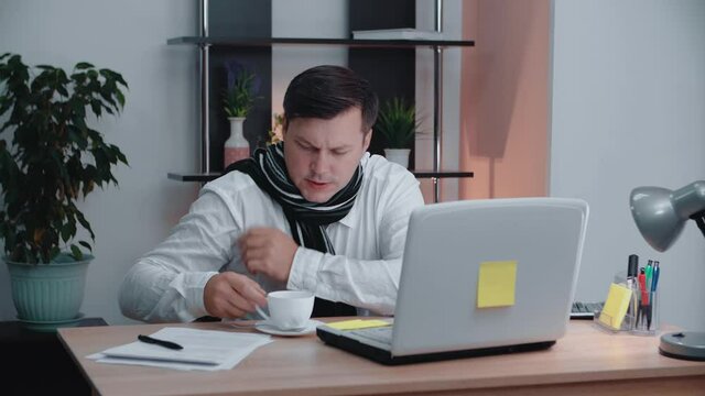 A man freezes at his workplace working at a computer.Freezes at home.