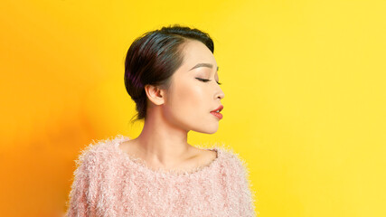 Young woman looking cute with sweater on colorful background