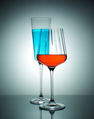 Two wine glasses. Colourfull water