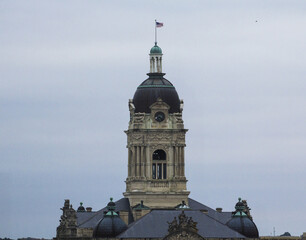 Upper part of Vanderburgh County Courthouse in Evansville, Indiana against the cloudy sky