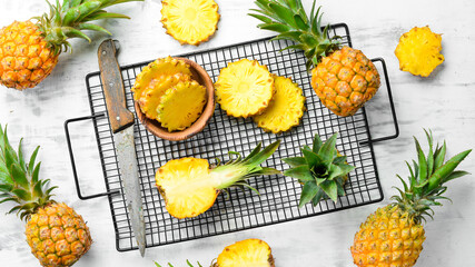 Mini pineapple on wooden table. Top view. Free space for text.