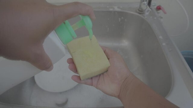 Man washing plates with sponge,Slog3