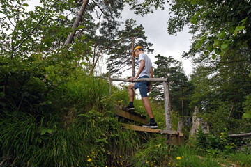 Teenager walking in mountain forest