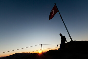 silhouette of a person on the top of mountain