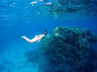 Young woman dive in Red Sea in snorkeling mask