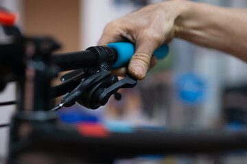 close-up changes mountain bike with mechanic in bike shop with blue fist