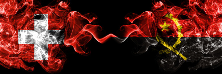Switzerland, Swiss vs Angola, Angolan smoky mystic flags placed side by side. Thick colored silky abstract smoke flags.