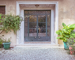 Fototapeta na wymiar contemporary classic design apartment building front entrance door and potted plants, Athens Greece