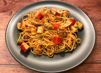 Spaghetti pasta with various seafood in tomato sauce.