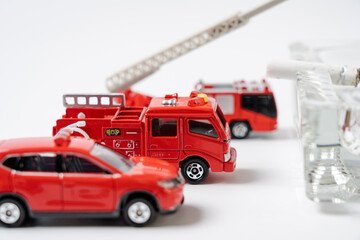 A miniature fire engine is extinguishing the ashtray..Image of fire prevention.
