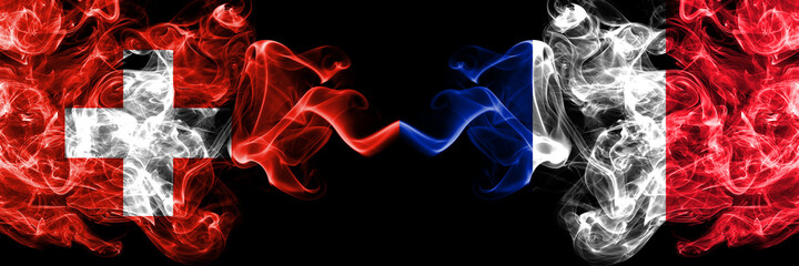 Switzerland, Swiss vs France, French smoky mystic flags placed side by side. Thick colored silky abstract smoke flags.
