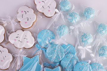 gingerbread white clouds and blue stars in transparent bags. sweet table for children's birthday