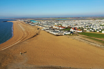 Aerial Photo of the large beach at Selsey in West Sussex with the large holiday caravan park at this destination.