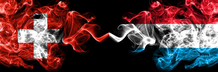 Switzerland, Swiss vs Luxembourg smoky mystic flags placed side by side. Thick colored silky abstract smoke flags.