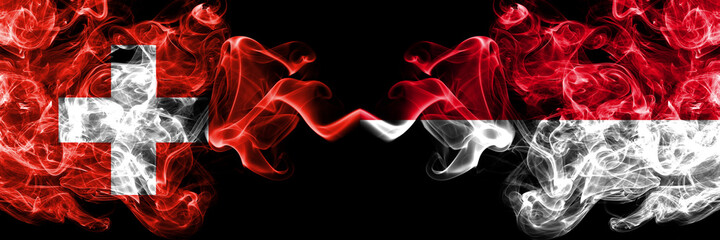 Switzerland, Swiss vs Monaco, Monacan smoky mystic flags placed side by side. Thick colored silky abstract smoke flags.