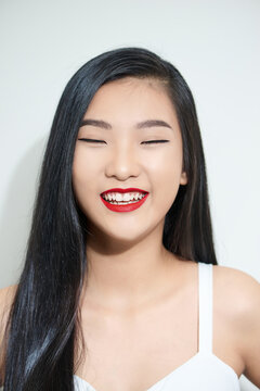Young beautiful Asian woman with smiley face and red lips.