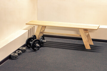dumbbells and bench for sports in the gym