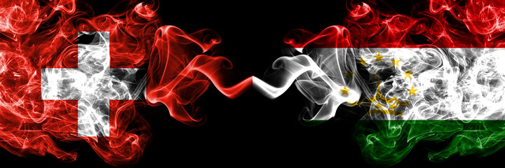 Switzerland, Swiss vs Tajikistan smoky mystic flags placed side by side. Thick colored silky abstract smoke flags.