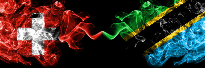 Switzerland, Swiss vs Tanzania smoky mystic flags placed side by side. Thick colored silky abstract smoke flags.