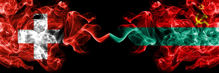 Switzerland, Swiss vs Transnistria smoky mystic flags placed side by side. Thick colored silky abstract smoke flags.